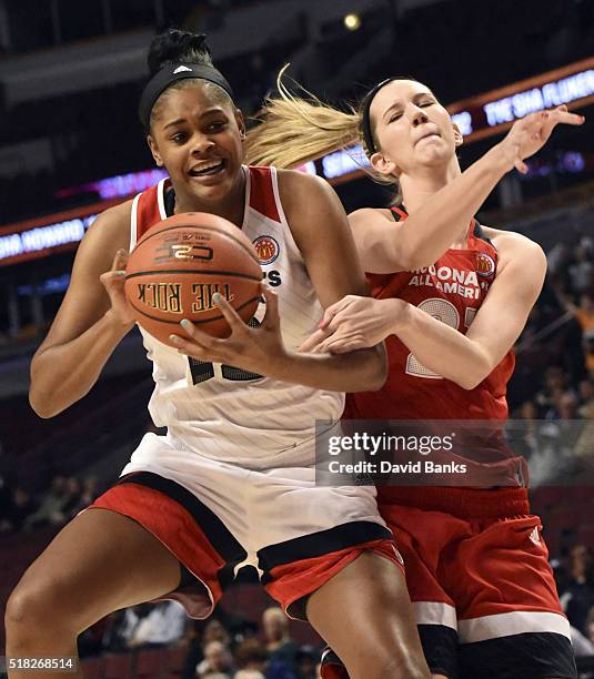 Tori McCoy of the West team is defended by Nancy Mulkey of the East team during the 2016 McDonalds's All American Game on March 30, 2016 at the...