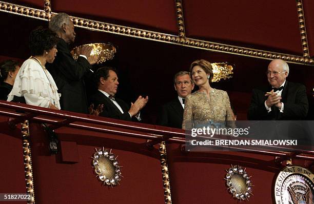 President George W Bush and First Lady Laura Bush receive an applause from Vice President Dick Cheney Roland Betts , friend of the president, Ossie...