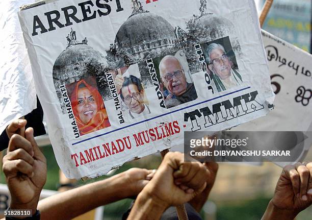 Indian Muslims shout slogans as they hold a placards bearing pictures of the leaders who are accused in the Babri Masjid Demolition case during a...