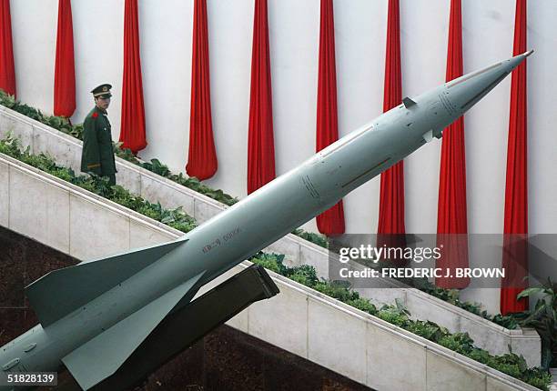 Soldier walks down a stairway behind a Chinese-made Hongqi-2 missile on display at the Military Museum in Beijing, 06 December 2004. China will urge...