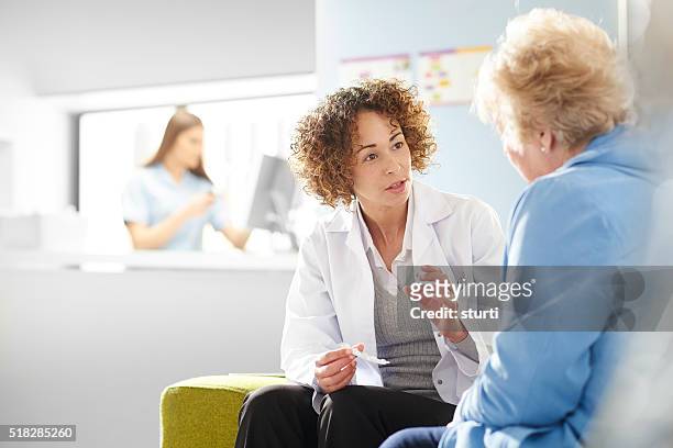 medicine advice - doctor looking over shoulder stock pictures, royalty-free photos & images