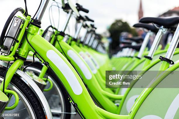 bicycles waiting for rent - bike sharing stock pictures, royalty-free photos & images