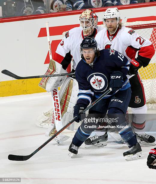 Matt Halischuk of the Winnipeg Jets, goaltender Andrew Hammond and Michael Kostka of the Ottawa Senators keep an eye on the play during second period...
