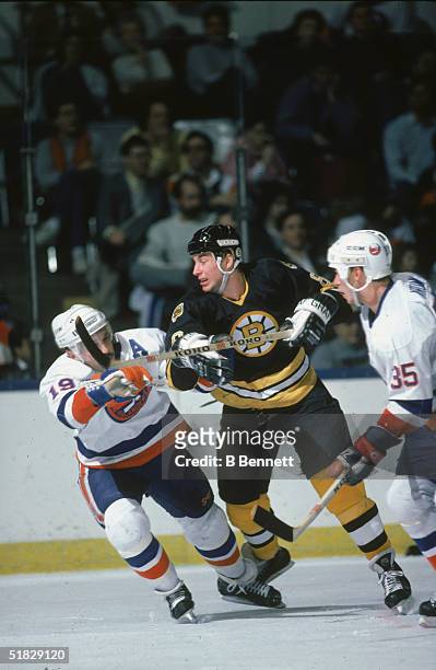 Canadian ice hockey player Cam Neely of the Boston Bruins fights for position with Bryan Trottier of the New York Islanders during a game at the...