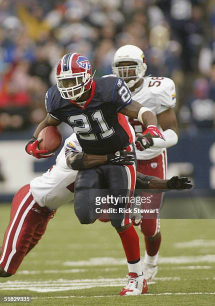 Running back Willis McGahee of the Buffalo Bills attempts to break the tackle of safety Adrian Wilson of the Arizona Cardinals during the game on...