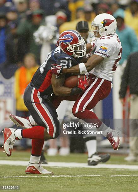 Running back Willis McGahee of the Buffalo Bills attempts to break the tackle of cornerback David Macklin of the Arizona Cardinals during the game on...