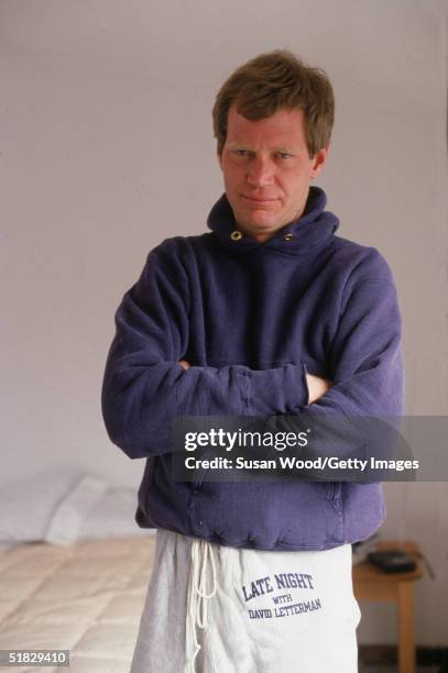 American talk show host David Letterman poses with his arms crossed wearing a 'Late Night with David Letterman' sweatsuit at his home, Westchester...