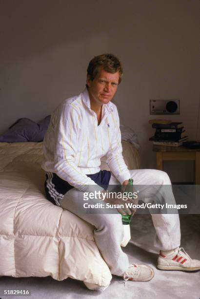 American talk show host David Letterman sits on his bed drinking Perrier at his home, Westchester County, New York, March 1984.