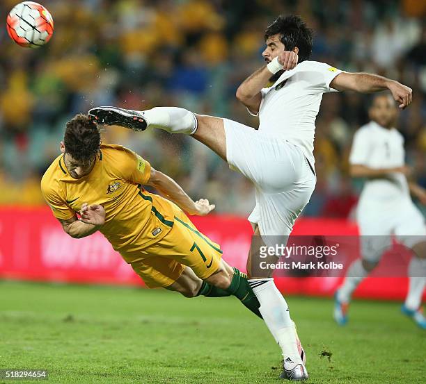 Mathew Leckie of Australia dives to head the ball as it is cleared by Mohammad Al Basha of Jordan during the 2018 FIFA World Cup Qualification match...