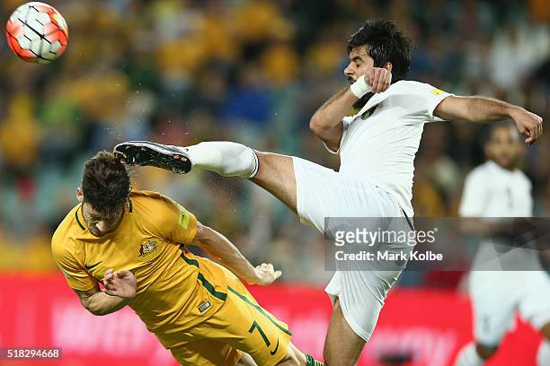 Mathew Leckie of Australia dives to head the ball as it is cleared by Mohammad Al Basha of Jordan during the 2018 FIFA World Cup Qualification match...
