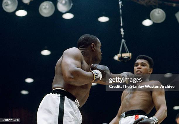 Cassius Clay reacts to a jab from Sonny Liston at the Convention Center in Miami Beach, Florida, February 25, 1964. Cassius Clay won the World...