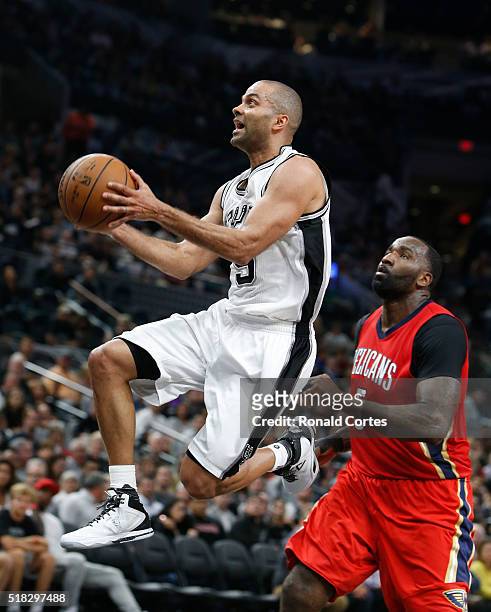 Tony Parker of the San Antonio Spurs drives past Kendrick Perkins of the New Orleans Pelicans at AT&T Center on March 30, 2016 in San Antonio, Texas....