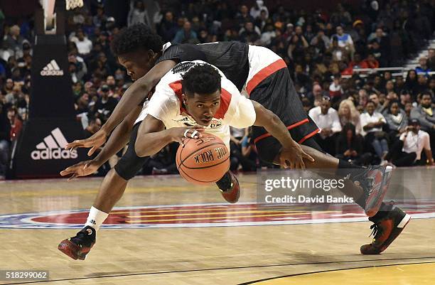 Alterique Gilbert of the West team drives past Andrew Jones of the East team during the 2016 McDonalds's All American Game on March 30, 2016 at the...