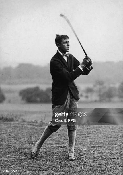 American golfer Francis Ouimet holds his club as he watches his shot travel down the course, 1910s. Ouimet won the 1913 U.S. Open as 20-year-old...