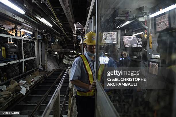 This picture taken on March 11, 2016 shows labourers working in a tunnel under construction along the current extension of the Metropolitan Rapid...