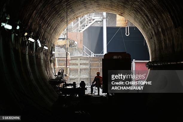 This picture taken on March 11, 2016 shows labourers working in a tunnel under construction along the current extension of the Metropolitan Rapid...