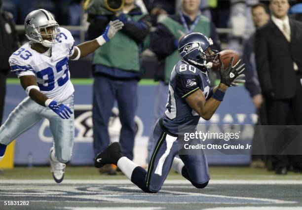 Wide receiver Jerry Rice of the Seattle Seahawks makes a 27 yard touchdown catch in the first quarter against Nathan Jones of the Dallas Cowboys on...