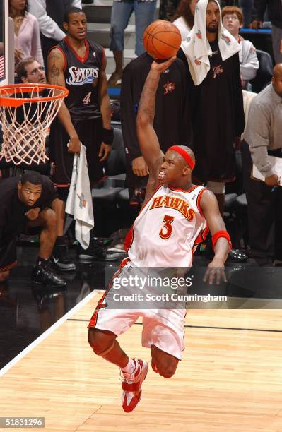 Al Harrington of the Atlanta Hawks goes up for a dunk against the Philadelphia 76ers during a game on December 6, 2004 at Philips Arena in Atlanta,...