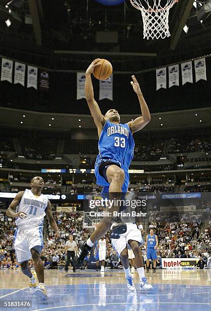 Grant Hill of the Orlando Magic shoots against the Denver Nuggets in the first half on December 6, 2004 at the Pepsi Center in Denver, Colorado. NOTE...