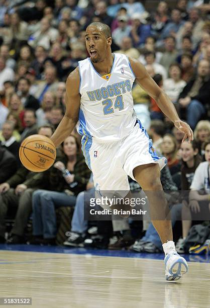 Andre Miller of the Denver Nuggets drives to the basket against the Orlando Magic in the first half on December 6, 2004 at the Pepsi Center in...