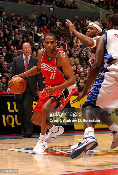 Steve Smith of the Charlotte Bobcats drives to the hoop against Corey Maggette and Elton Brand of the Los Angeles Clippers on December 6, 2004 at the...