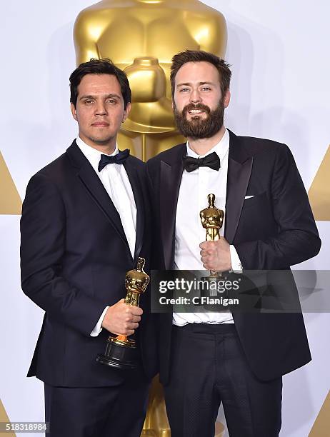 Producer Shan Christopher Ogilvie and director Benjamin Cleary , winners of the Best Live Action Short award for 'Stutterer pose in the press room...