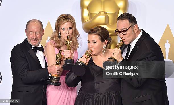 Producers Steve Golin, Blye Pagon Faust, Nicole Rocklin and Michael Sugar, winners of the Best Picture award for 'Spotlight,' pose in the press room...