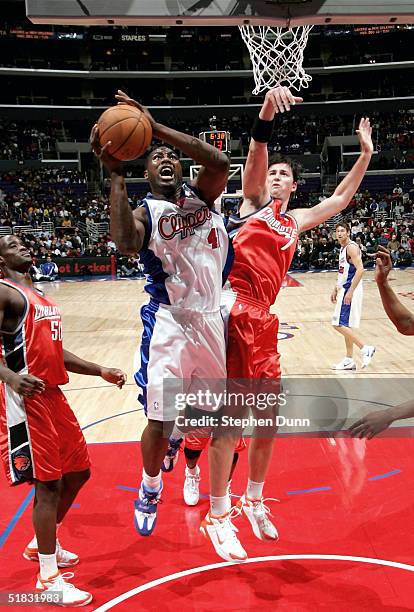 Elton Brand of the Los Angeles Clippers goes up for a shot against Primoz Brezec of the Charlotte Bobcats December 6, 2004 at Staples Center in Los...