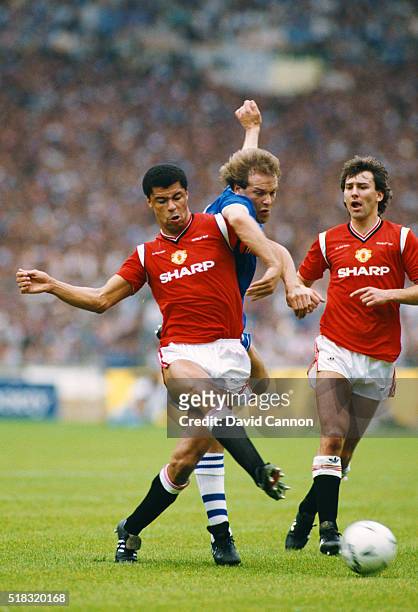 Everton striker Andy Gray is challenged by Paul McGrath as Bryan Robson looks on during the 1985 FA Cup Final between Everton and Manchester United...