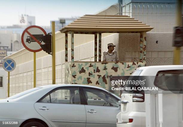 Saudi security guard monitors movement outside the walls of the US consulate in the Red Sea port city of Jeddah 07 December 2004. Osama bin Laden's...