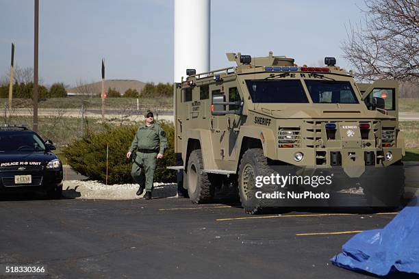 An armored vehicle issued to Walworth county sits in the parking lot during a campaign rally at Holiday Inn Express in Janesville, Wisconsin, United...