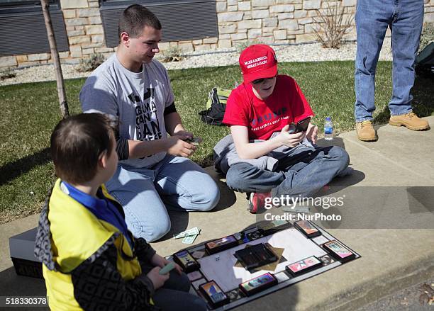 Children play Donald Trump's Art of the Deal board game during a campaign rally at Holiday Inn Express in Janesville, Wisconsin, United States on...