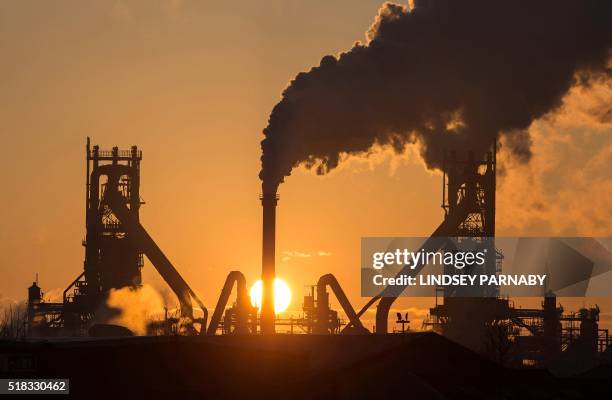 The sun rises above Tata Steel's blast furnaces at their Scunthorpe Plant in north east England, on March 31, 2016. Indian giant Tata Steel on...