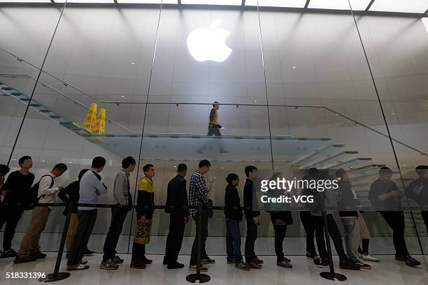 Citizens queue up outside an Apple Store as Apple launches its iPhone SE globally on Thursday on March 31, 2016 in Guangzhou, Guangdong Province of...
