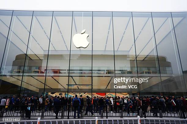 Citizens queue up outside an Apple Store as Apple launches its iPhone SE globally on Thursday on March 31, 2016 in Hangzhou, Zhejiang Province of...