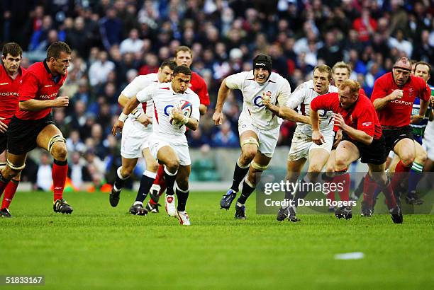 Jason Robinson of England makes a break during the RBS Six Nations match between England and Wales at Twickenham on March 20, 2004 in London.