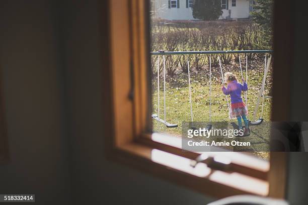 Child on a backyard Swing Set