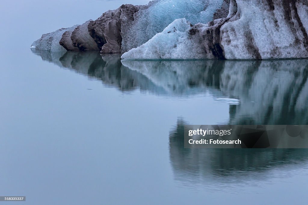Striped icebergs with reflection