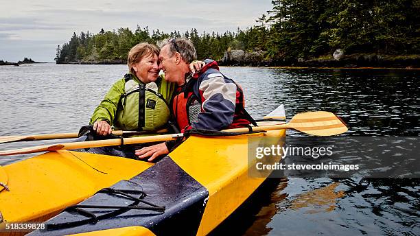 senior couple kayaking - seniors canoeing stock pictures, royalty-free photos & images