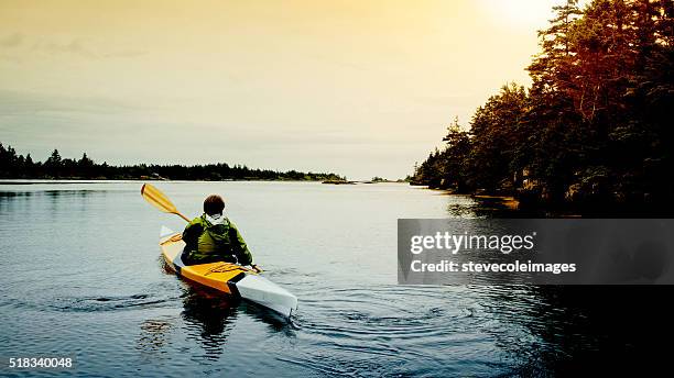 senior woman kayaking - seniors canoeing stock pictures, royalty-free photos & images