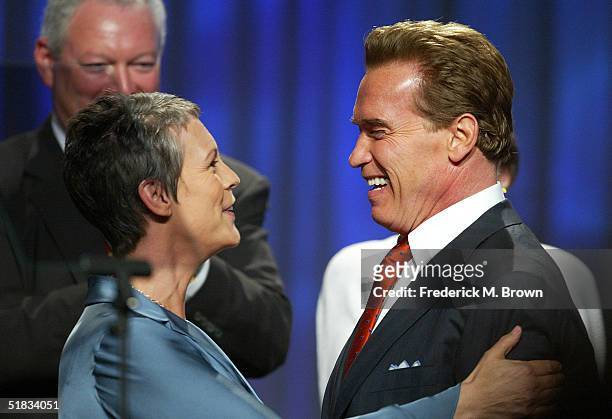 Actor Jamie Lee Curtis and California Governor Arnold Schwarzenegger hug during the California Governor's Conference on Women and Families at the...
