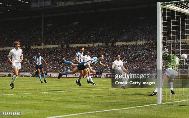 Coventry striker Keith Houchen dives to head the second goal past Spurs goalkeeper Ray Clemence as defender Chris Houghton reacts during the 1987 FA...
