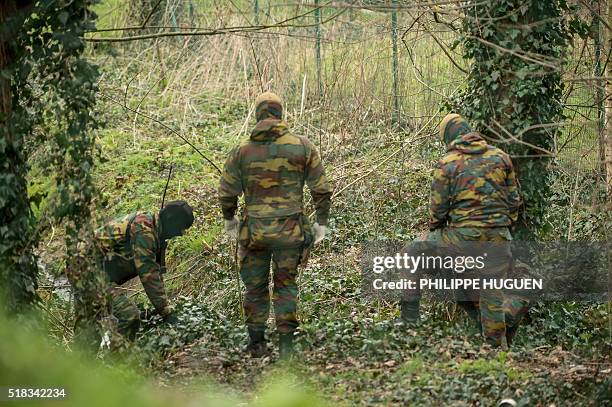 Belgium soldiers carry out a search operation in the Rodenburg neighbourhood of the city of Kortrijk in west Flanders on March 31, 2016. Belgian...