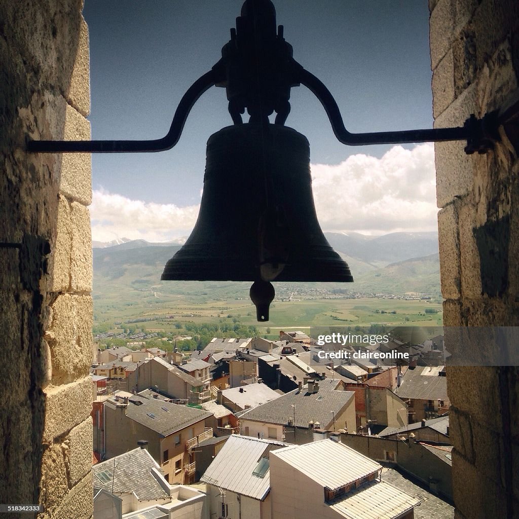 Spain, Catalunya, Puigcerda, View of town with silhouette of bell in foreground
