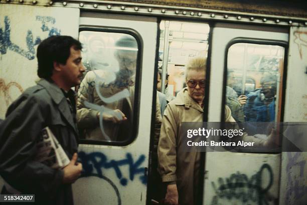 Commuters on a subway train in New York City, USA, circa 1980.