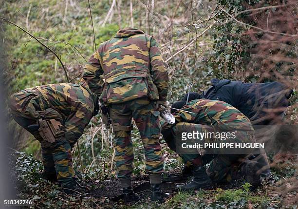 Belgium soldiers carry out a search operation in the Rodenburg neighbourhood of the city of Kortrijk in west Flanders on March 31, 2016. Belgian...