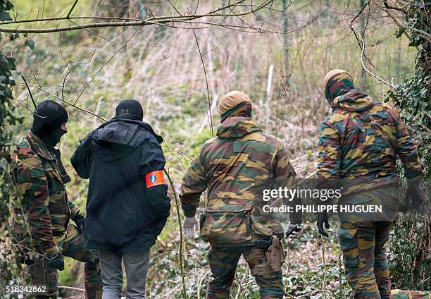 Belgium soldiers carry out a search operation in the Rodenburg neighbourhood of the city of Kortrijk in west Flanders on March 31, 2016. Belgian...