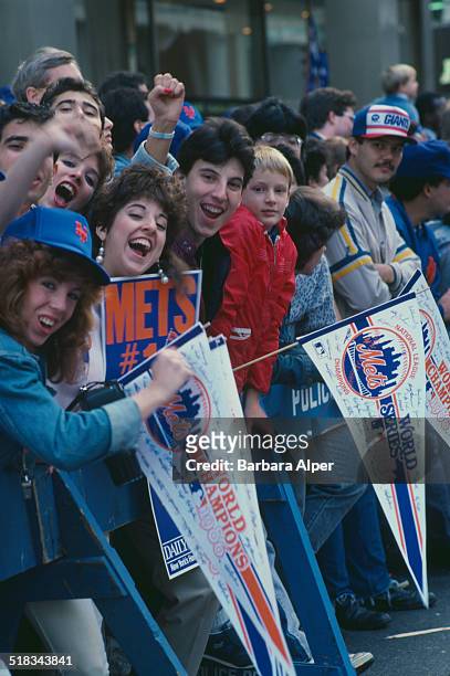 Fans on the route of a ticker tape parade to celebrate the New York Mets winning the World Series, New York City, USA, 28th October 1986.