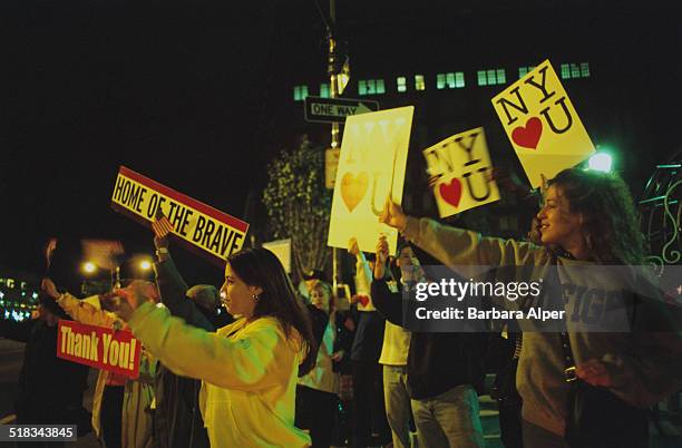 New Yorkers on West Street and 14th Street show their support for the emergency service workers removing rubble from the World Trade Center after the...