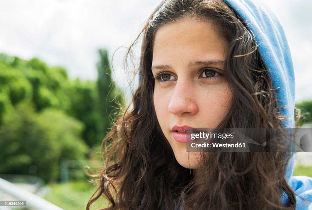 Portrait of young woman with hood